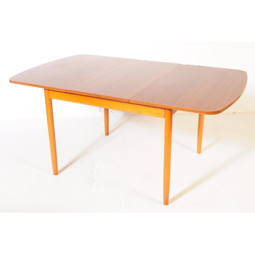 595 - British Modern Design - A retro mid 20th century formica topped dining table and four chairs. The di... 