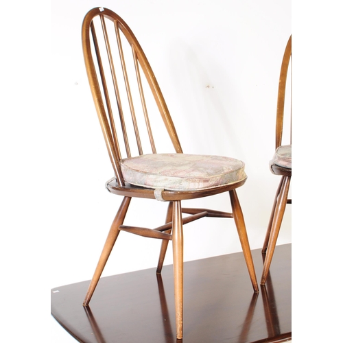 614 - Ercol - A mid 20th century Ercol beech and elm refectory dining table and four windsor style chairs.... 