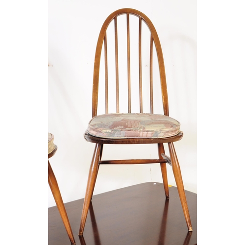 614 - Ercol - A mid 20th century Ercol beech and elm refectory dining table and four windsor style chairs.... 