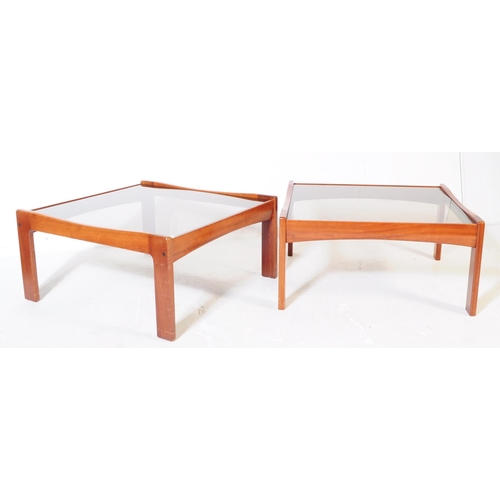 623 - British Modern Design - A pair of mid 20th century teak wood and smoked glass square coffee tables, ... 