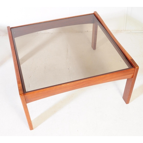 623 - British Modern Design - A pair of mid 20th century teak wood and smoked glass square coffee tables, ... 