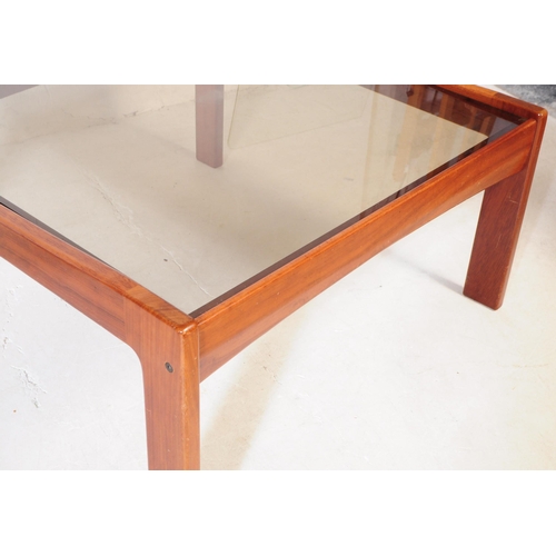 623 - British Modern Design - A pair of mid 20th century teak wood and smoked glass square coffee tables, ... 