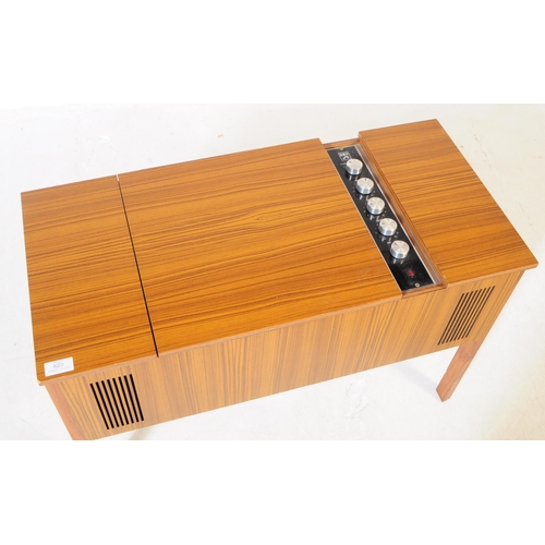 629 - A mid 20th century veneered HMV stereogram. Having hinged top with grill fascia, raised on squared l... 