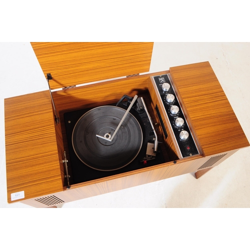 629 - A mid 20th century veneered HMV stereogram. Having hinged top with grill fascia, raised on squared l... 