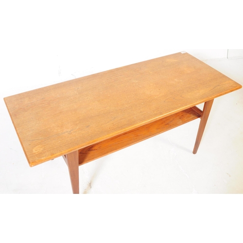 633 - British Modern Design - A mid 20th century teak wood long john coffee table. Raised on tapering legs... 