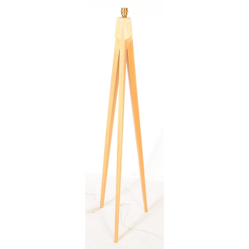 638 - A contemporary beech wood floor standing standard lamp, alongside a smaller table side lamp. The lam... 