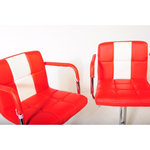 642 - A pair of contemporary red and white vinyl and chrome bar / kitchen breakfast stool chairs. The chai... 