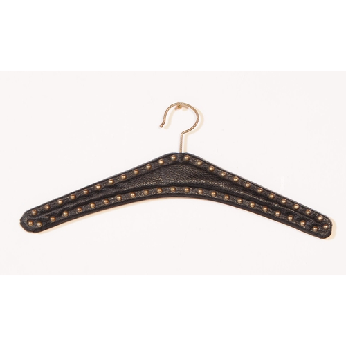 646 - A large extensive collection of vintage 20th century faux leather and stud coat clothes hangers. Com... 