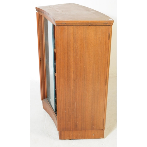 649 - Turnidge of London - A mid 20th century teak cocktail drinks cabinet. With twin hinged doors to fron... 