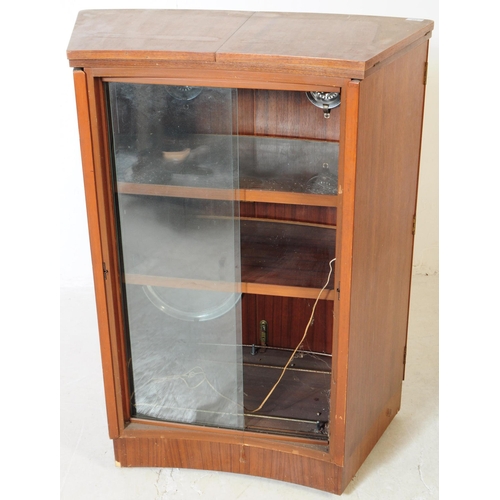 649 - Turnidge of London - A mid 20th century teak cocktail drinks cabinet. With twin hinged doors to fron... 