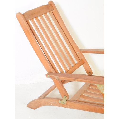 651 - A pair of 20th century teak wood garden furniture folding reclining deck armchairs. The chairs each ... 