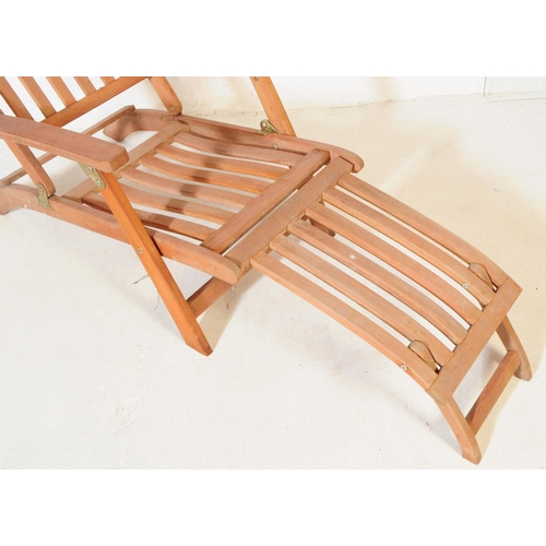 651 - A pair of 20th century teak wood garden furniture folding reclining deck armchairs. The chairs each ... 