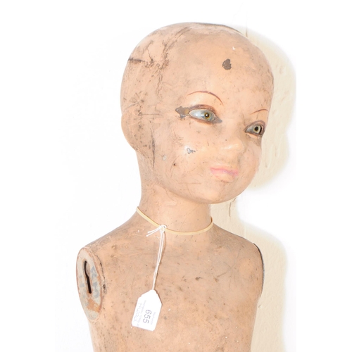 655 - A vintage mid Century child's mannequin doll together with another head. AF. Measuring approximately... 