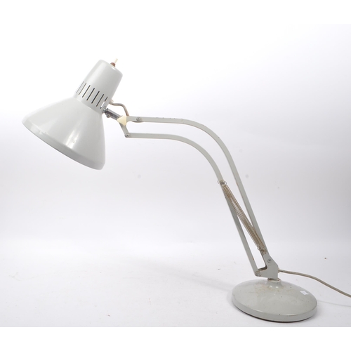 656 - A mid Century metal industrial table top lamp having grey ground spring loaded support arm upon a ci... 