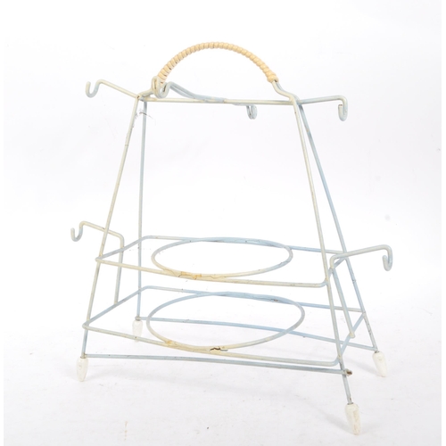 663 - A collection of mid 20th century sputnik atomic style magazine racks and other wire racks. The colle... 