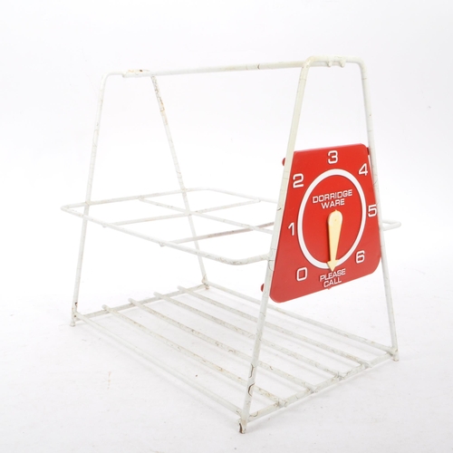 663 - A collection of mid 20th century sputnik atomic style magazine racks and other wire racks. The colle... 