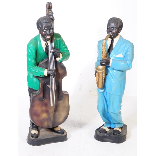 676 - Two vintage mid 20th century theatre production prop male jazz players statues / figures. Both in a ... 