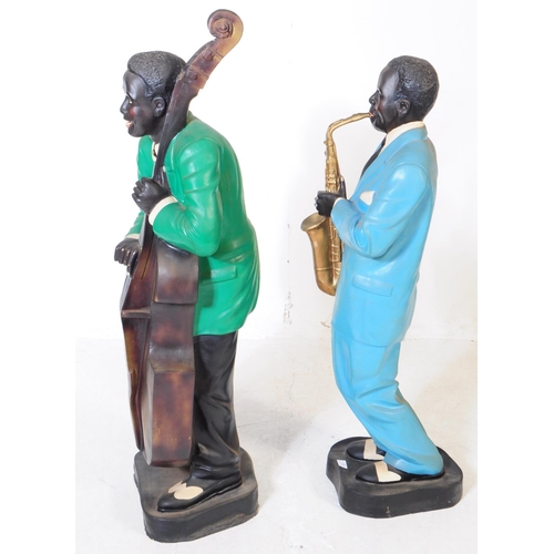 676 - Two vintage mid 20th century theatre production prop male jazz players statues / figures. Both in a ... 