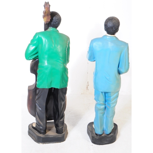 676 - Two vintage mid 20th century theatre production prop male jazz players statues / figures. Both in a ... 