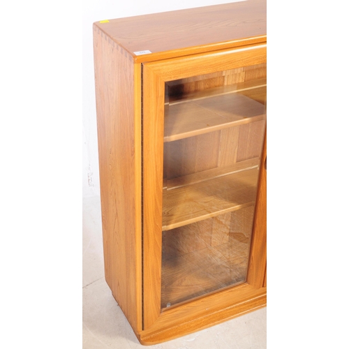 678 - Ercol - Model 810 - A 20th century Ercol Model 810 golden dawn blonde elm display cabinet bookcase. ... 