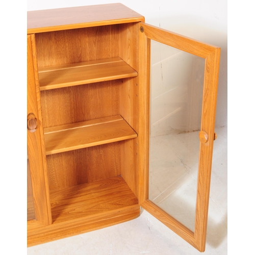 678 - Ercol - Model 810 - A 20th century Ercol Model 810 golden dawn blonde elm display cabinet bookcase. ... 