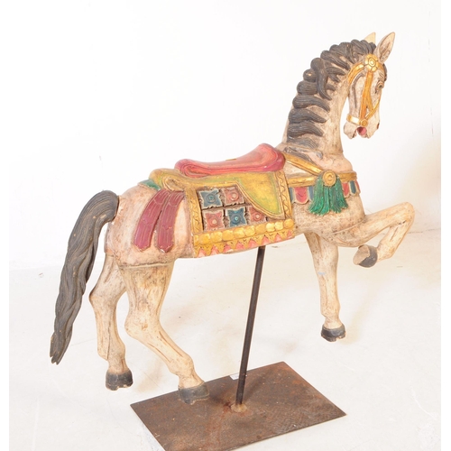 683 - A mid 20th century European merry go round carousel hand carved wooden horse. In a white ground with... 