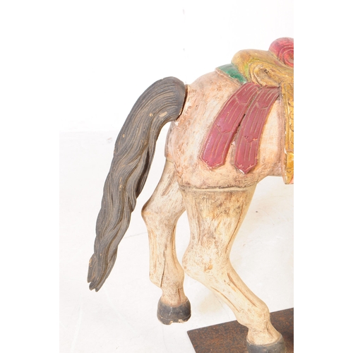 683 - A mid 20th century European merry go round carousel hand carved wooden horse. In a white ground with... 