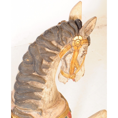 683 - A mid 20th century European merry go round carousel hand carved wooden horse. In a white ground with... 