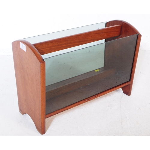 692 - British Modern Design - A mid 20th century teak wood and smoked glass magazine rack alongside anothe... 