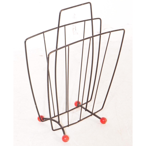 692 - British Modern Design - A mid 20th century teak wood and smoked glass magazine rack alongside anothe... 