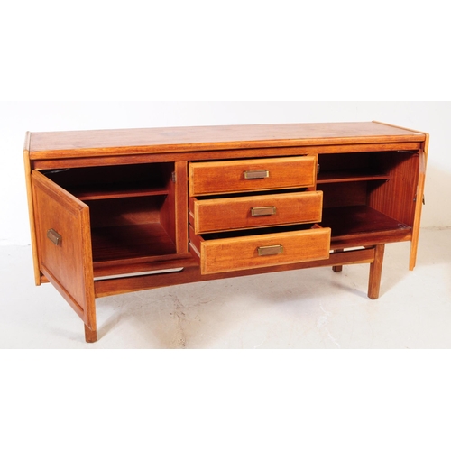 696 - British Modern Design - A mid 20th century teak wood sideboard credenza. The sideboard having a bank... 