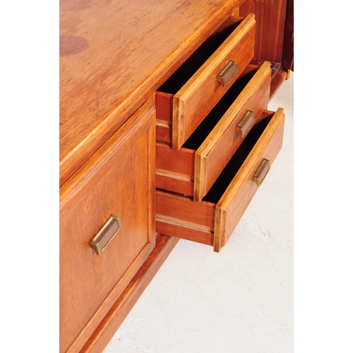 696 - British Modern Design - A mid 20th century teak wood sideboard credenza. The sideboard having a bank... 