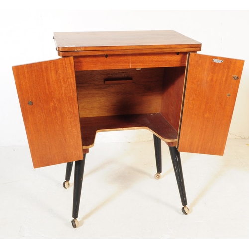 698 - A retro mid 20th century veneered sewing cabinet cupboard. The cupboard having twin doors to front w... 