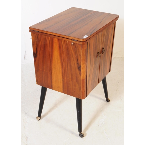 698 - A retro mid 20th century veneered sewing cabinet cupboard. The cupboard having twin doors to front w... 