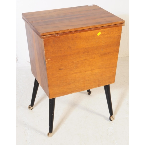 698 - A retro mid 20th century veneered sewing cabinet cupboard. The cupboard having twin doors to front w... 