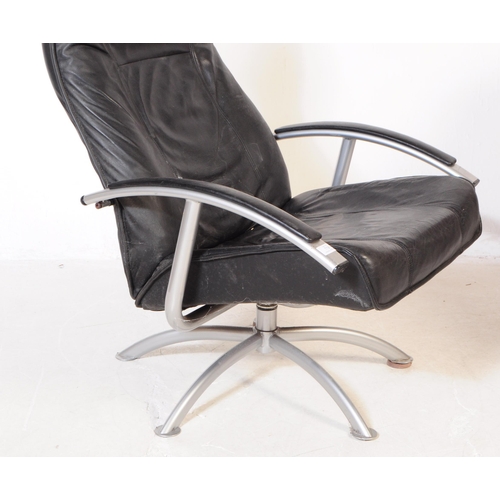 719 - A contemporary leather upholstered swivel armchair / office chair. The chair raised on splayed legs,... 