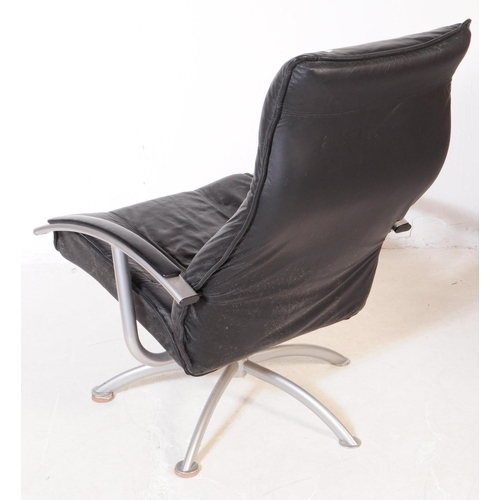 719 - A contemporary leather upholstered swivel armchair / office chair. The chair raised on splayed legs,... 