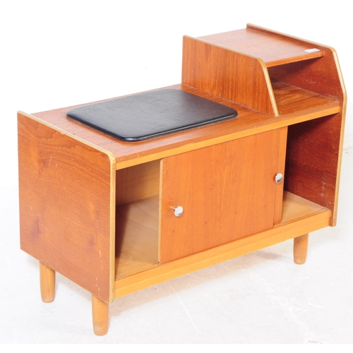 727 - A retro mid 20th century teak veneer telephone table. Rectangular form with raised platform with pig... 