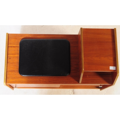 727 - A retro mid 20th century teak veneer telephone table. Rectangular form with raised platform with pig... 