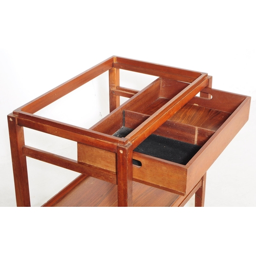 728 - A vintage later 20th century teak two tier serving / butler's trolley. Rectangular form with gallery... 