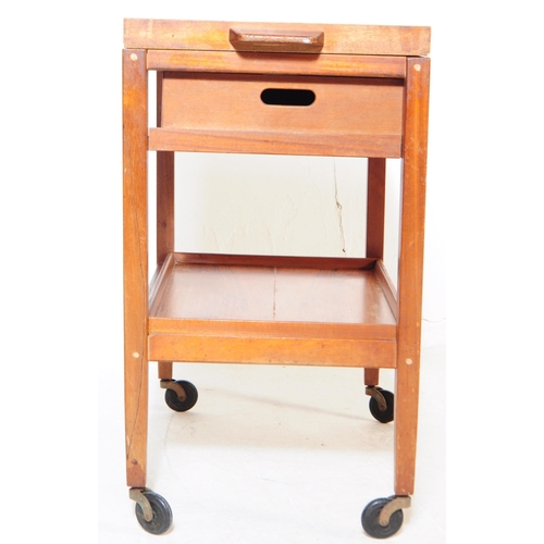 728 - A vintage later 20th century teak two tier serving / butler's trolley. Rectangular form with gallery... 