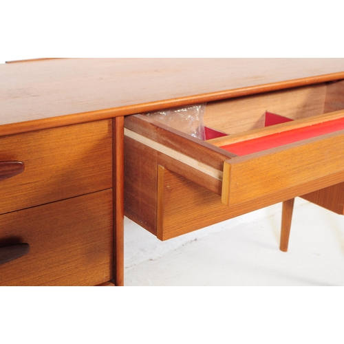 733 - Austinsuite Furniture - A mid 20th century Austinsuite teak veneered dressing table desk. The dresse... 