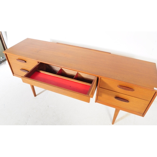 733 - Austinsuite Furniture - A mid 20th century Austinsuite teak veneered dressing table desk. The dresse... 