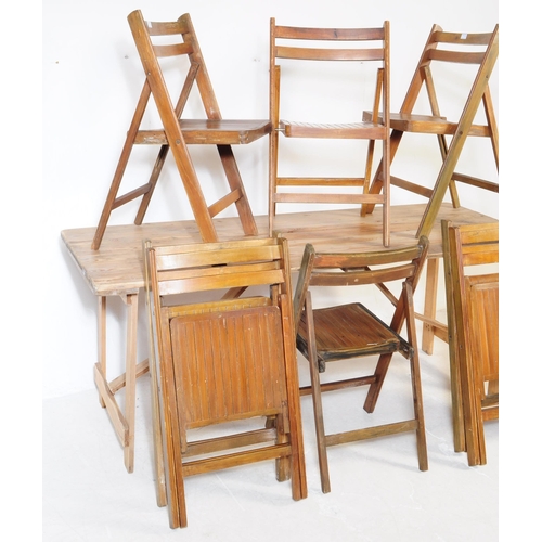 737 - A mid 20th century oak wood trestle folding table and chairs. The table of rectangular form, raised ... 