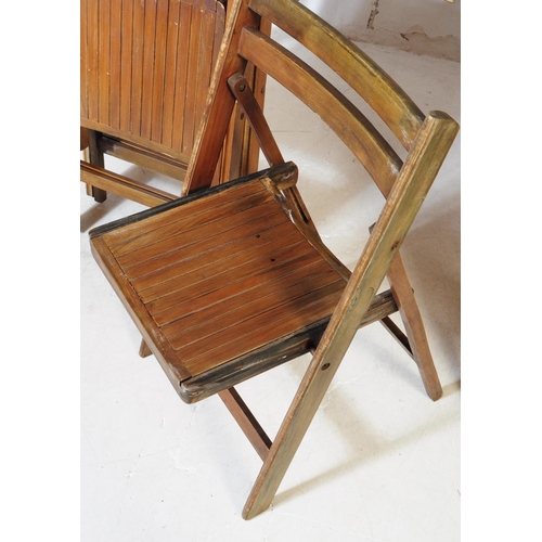 737 - A mid 20th century oak wood trestle folding table and chairs. The table of rectangular form, raised ... 