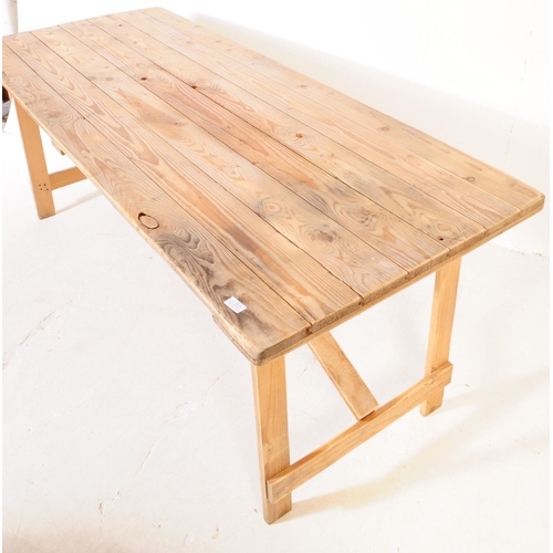 737 - A mid 20th century oak wood trestle folding table and chairs. The table of rectangular form, raised ... 