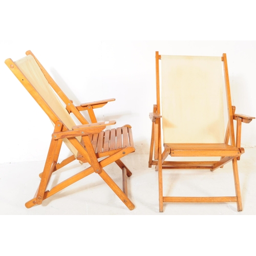 738 - A pair of 20th century folding garden furniture deck chairs. The chairs each having wooden metamorph... 