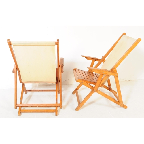 738 - A pair of 20th century folding garden furniture deck chairs. The chairs each having wooden metamorph... 