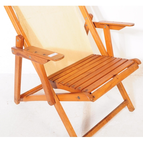 738 - A pair of 20th century folding garden furniture deck chairs. The chairs each having wooden metamorph... 