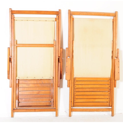 738 - A pair of 20th century folding garden furniture deck chairs. The chairs each having wooden metamorph... 